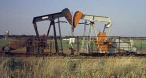 Heavy oil pump jacks in a rural oilfield setting.