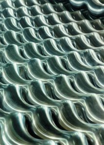 Shiny metallic roofing tiles for durable building exterior, ALRDC roofing solutions.