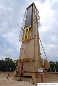 Industrial oil drilling rig tower in outdoor construction site, high-tech petroleum extraction equipment.