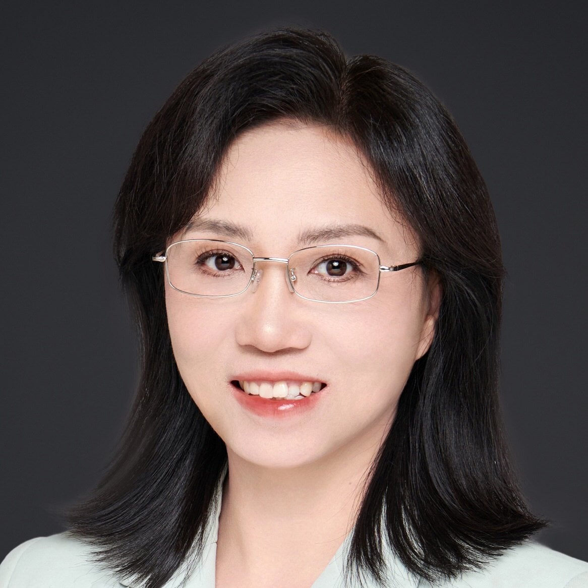 Professional woman in glasses representing the Board of Directors.